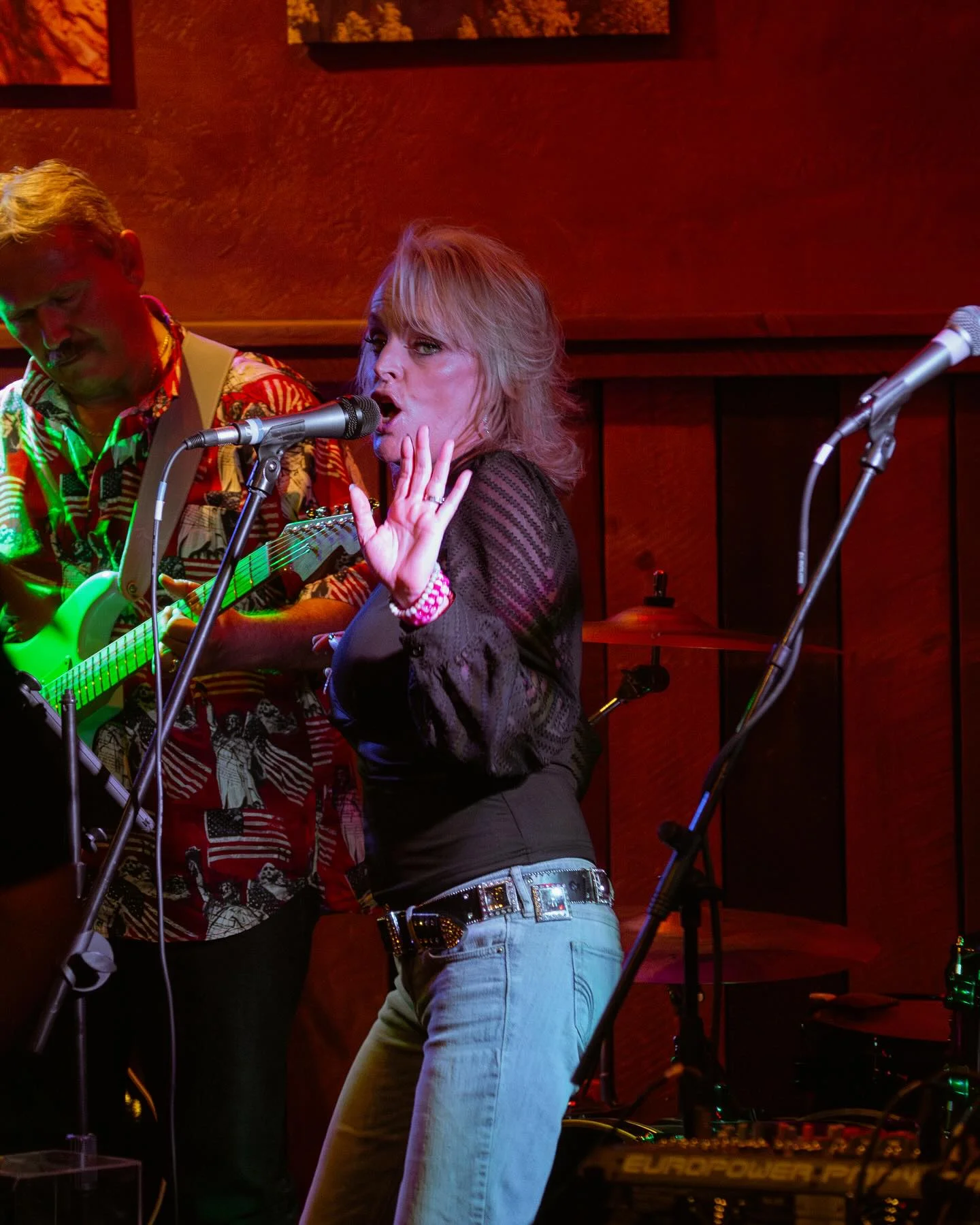 Live music performance with singer and guitarist on stage