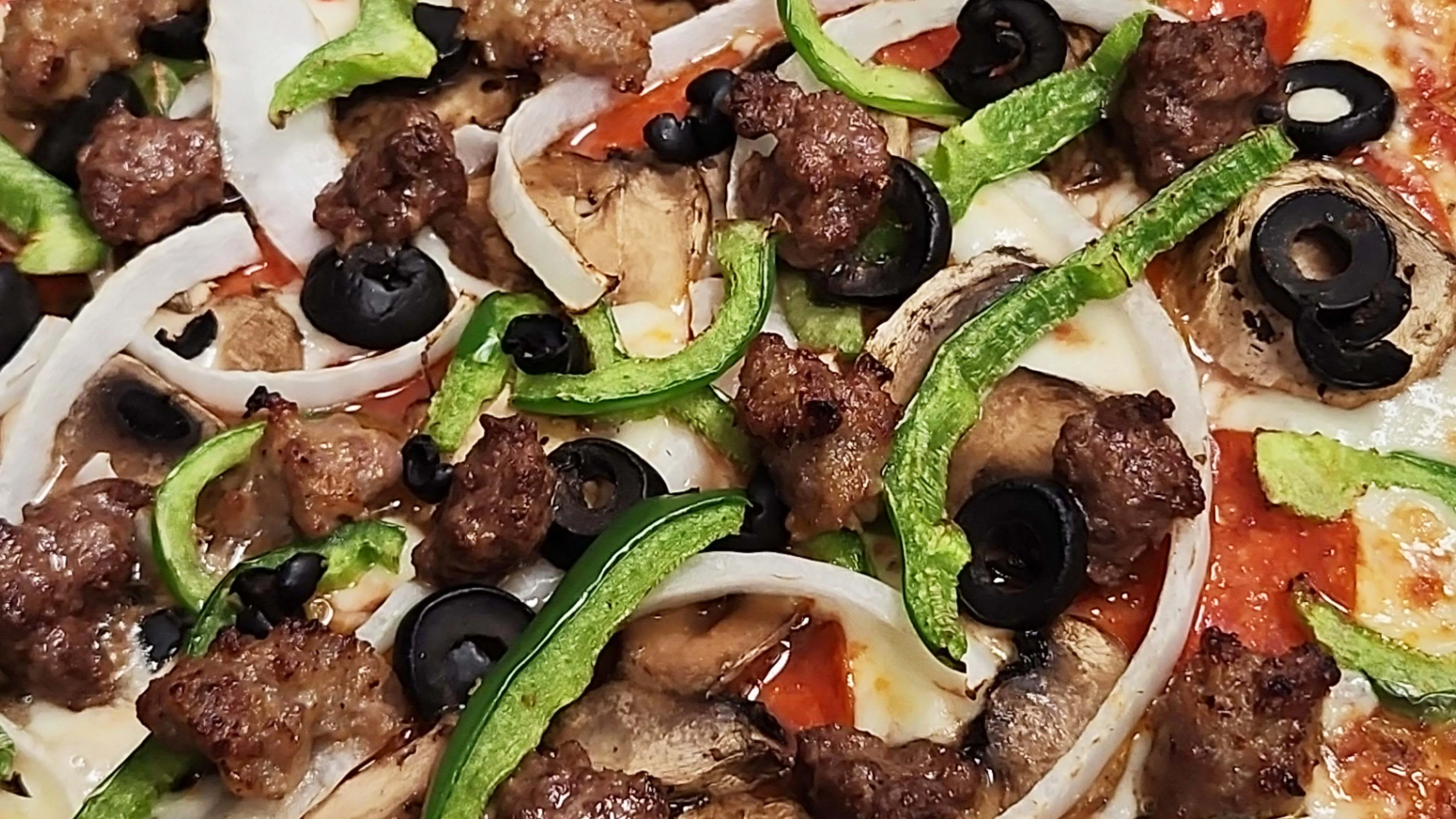 Delicious Italian pizza topped with sausage and vegetables