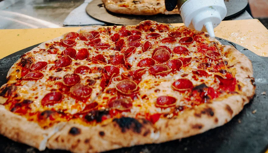 Delicious assortment of pizzas on a wooden table.