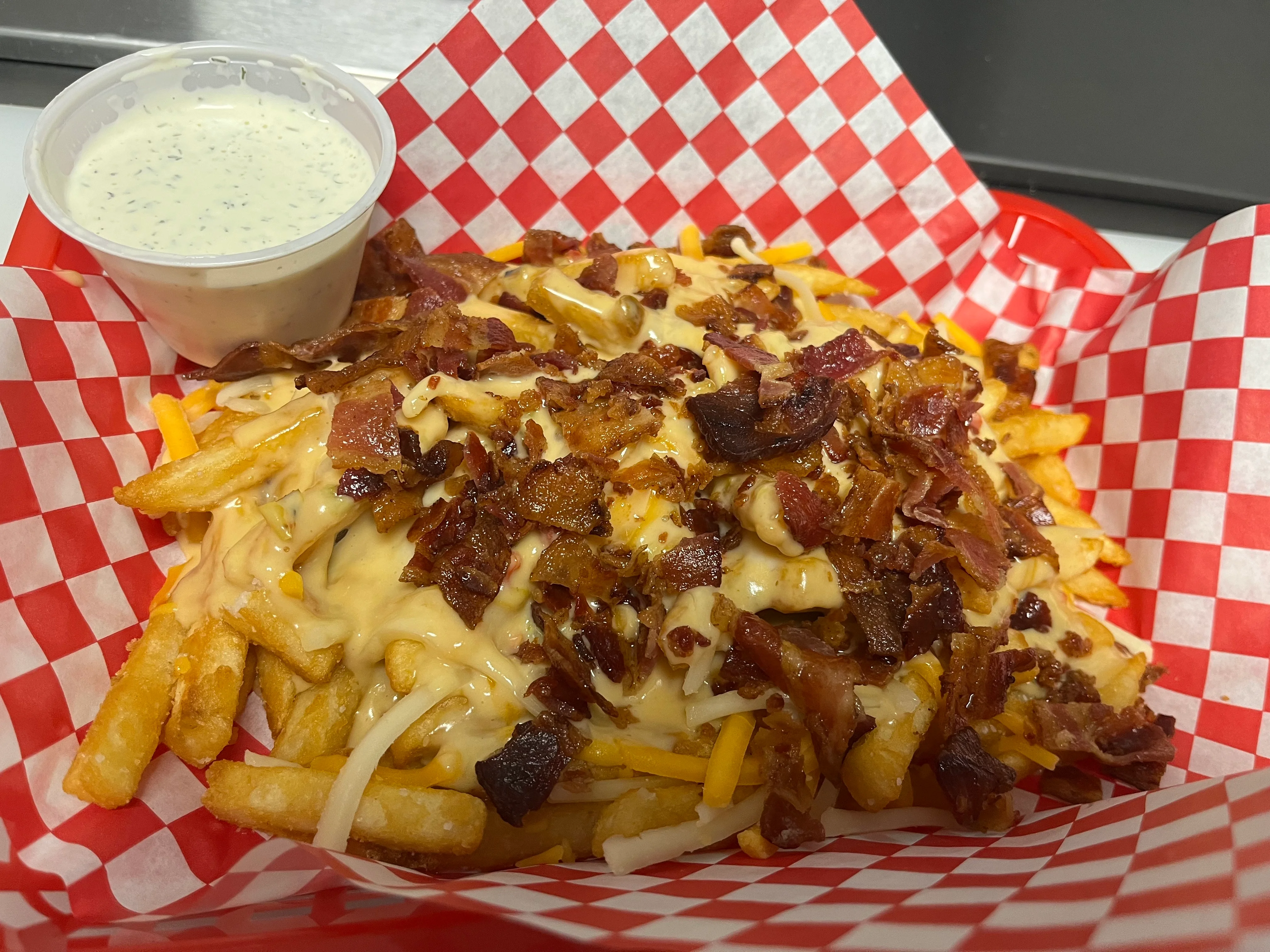 Loaded Canadian poutine with bacon and cheese sauce