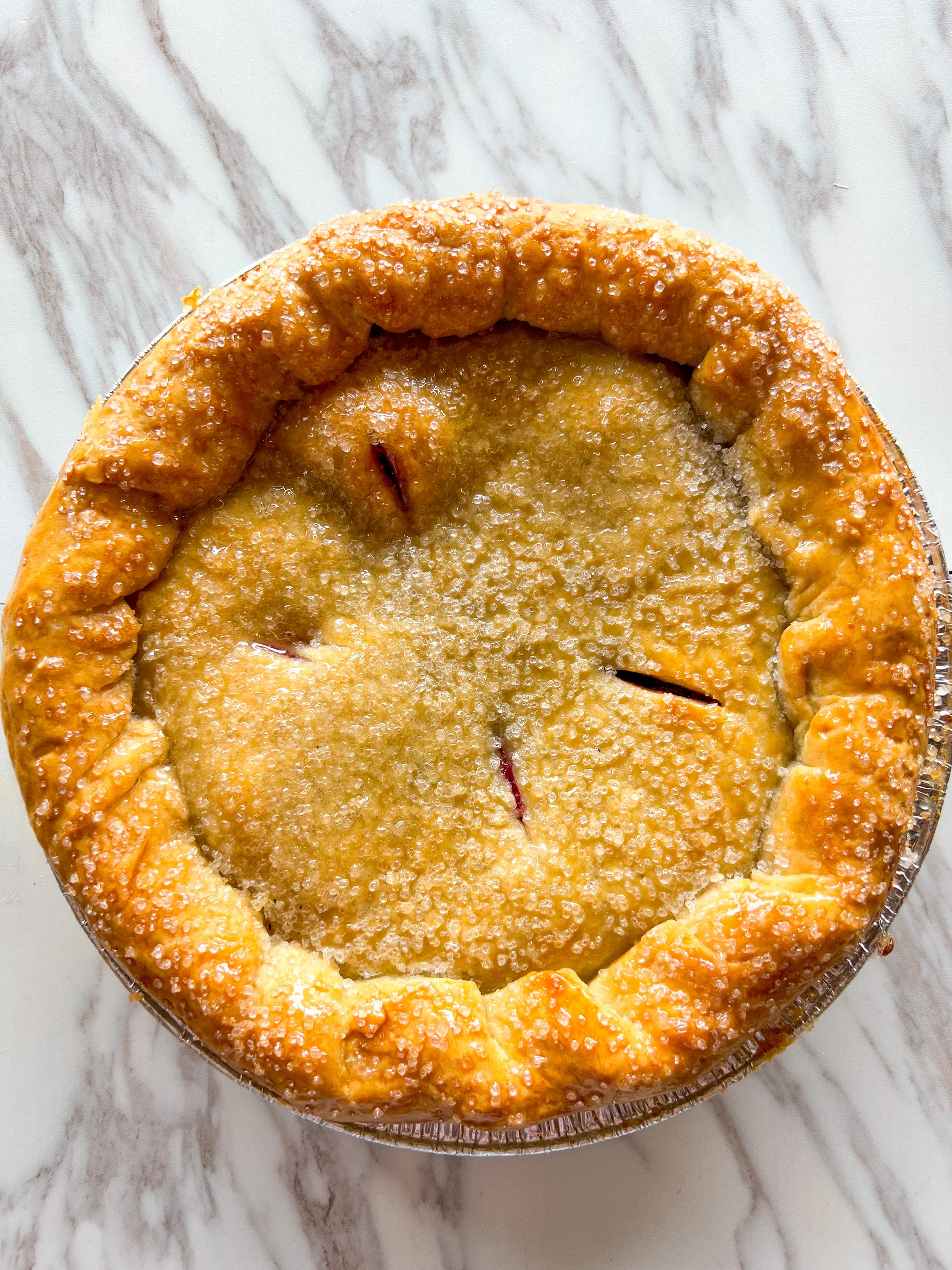 Golden apple pie with a flaky crust and sparkling sugar topping