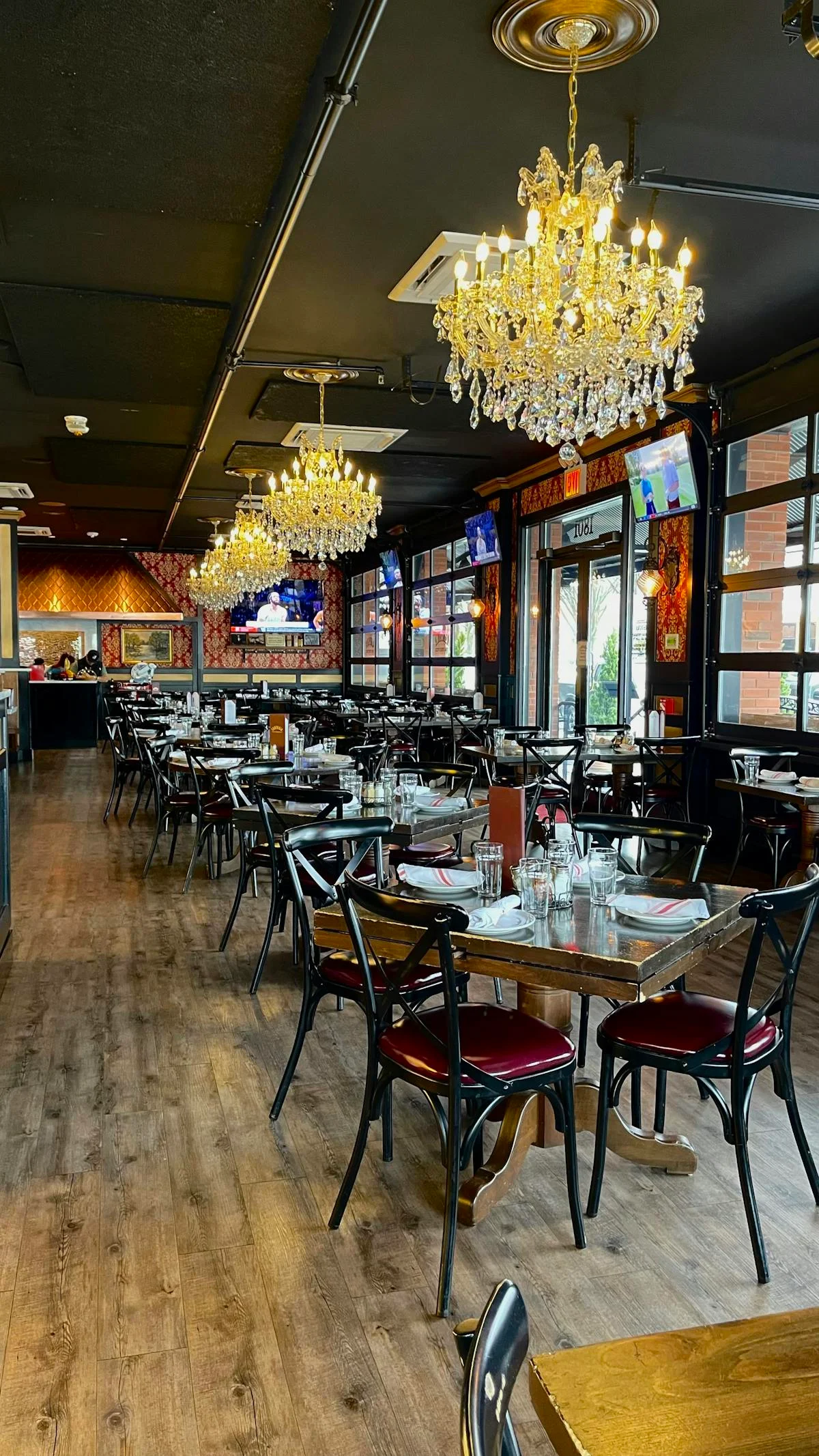 Elegant restaurant interior with chandeliers and wooden tables