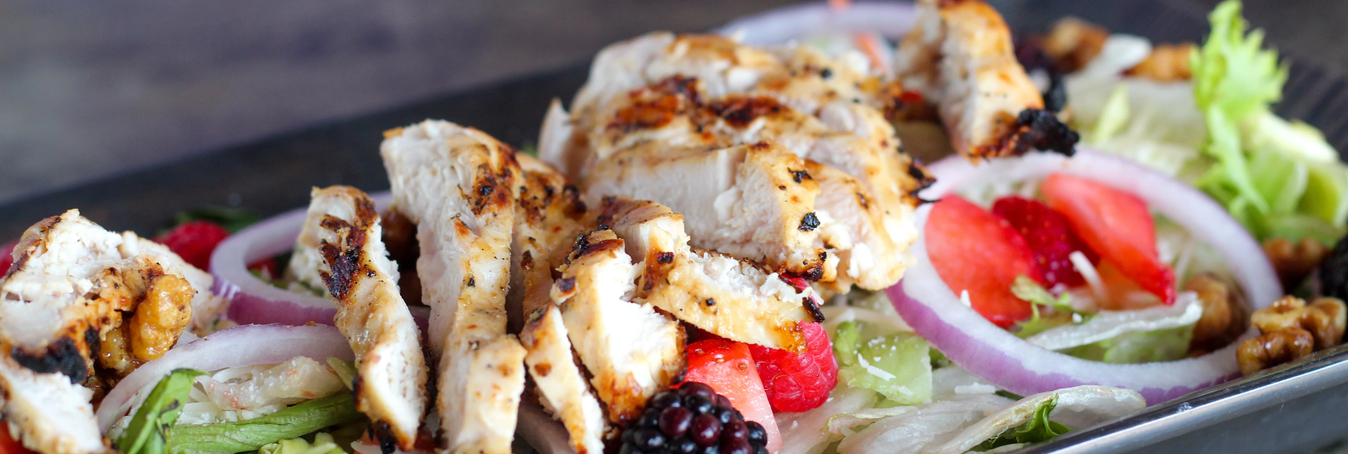 Grilled chicken salad with mixed greens and berries