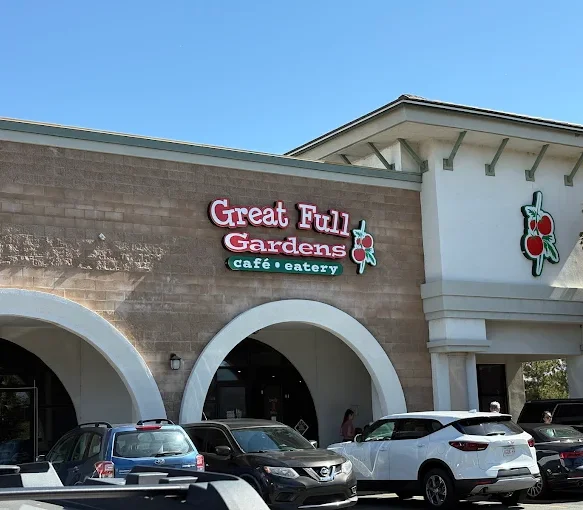 Great Ell Gardens cafe exterior with arched entrance and colorful signage