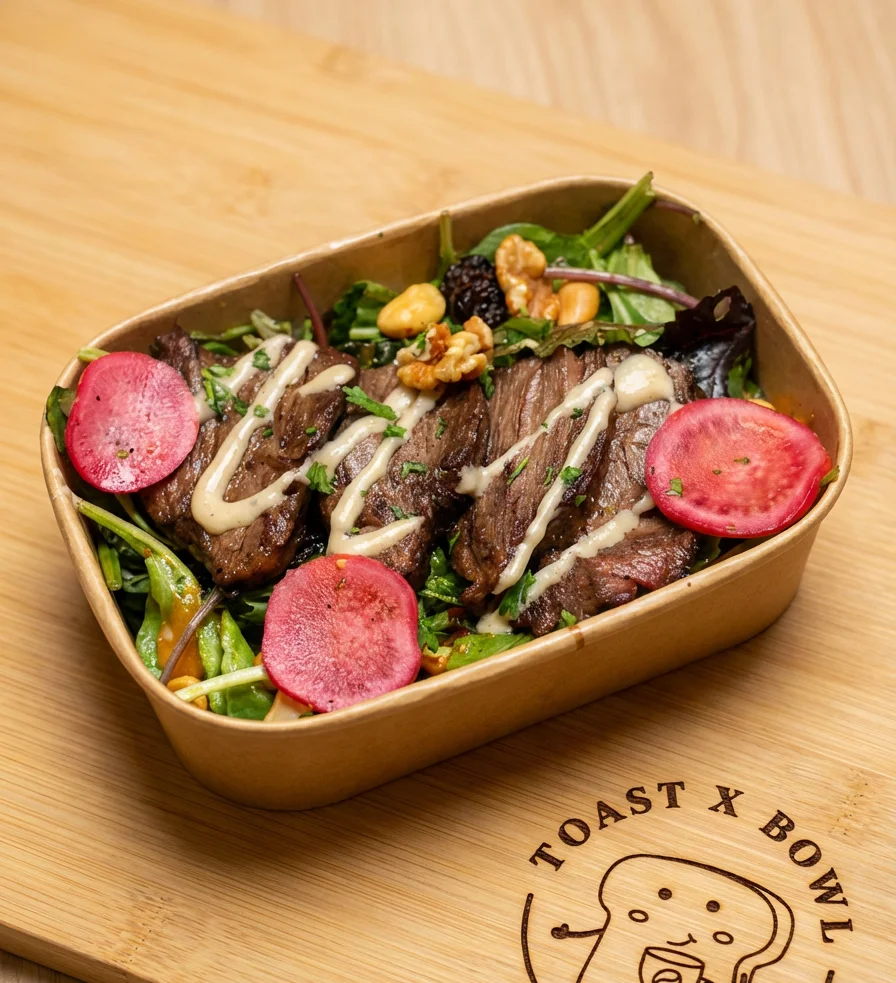 Grilled beef salad with fresh greens and vibrant toppings