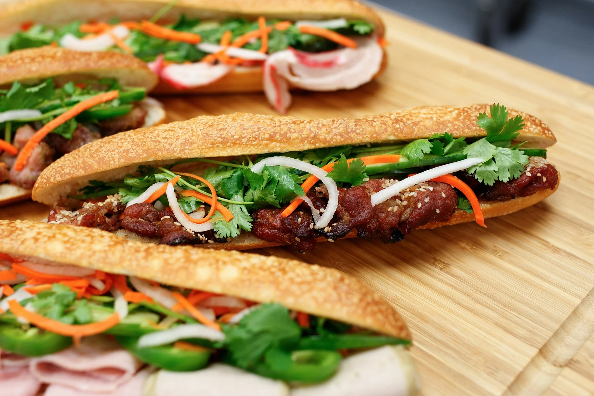 Vietnamese banh mi sandwich with grilled meat and fresh herbs