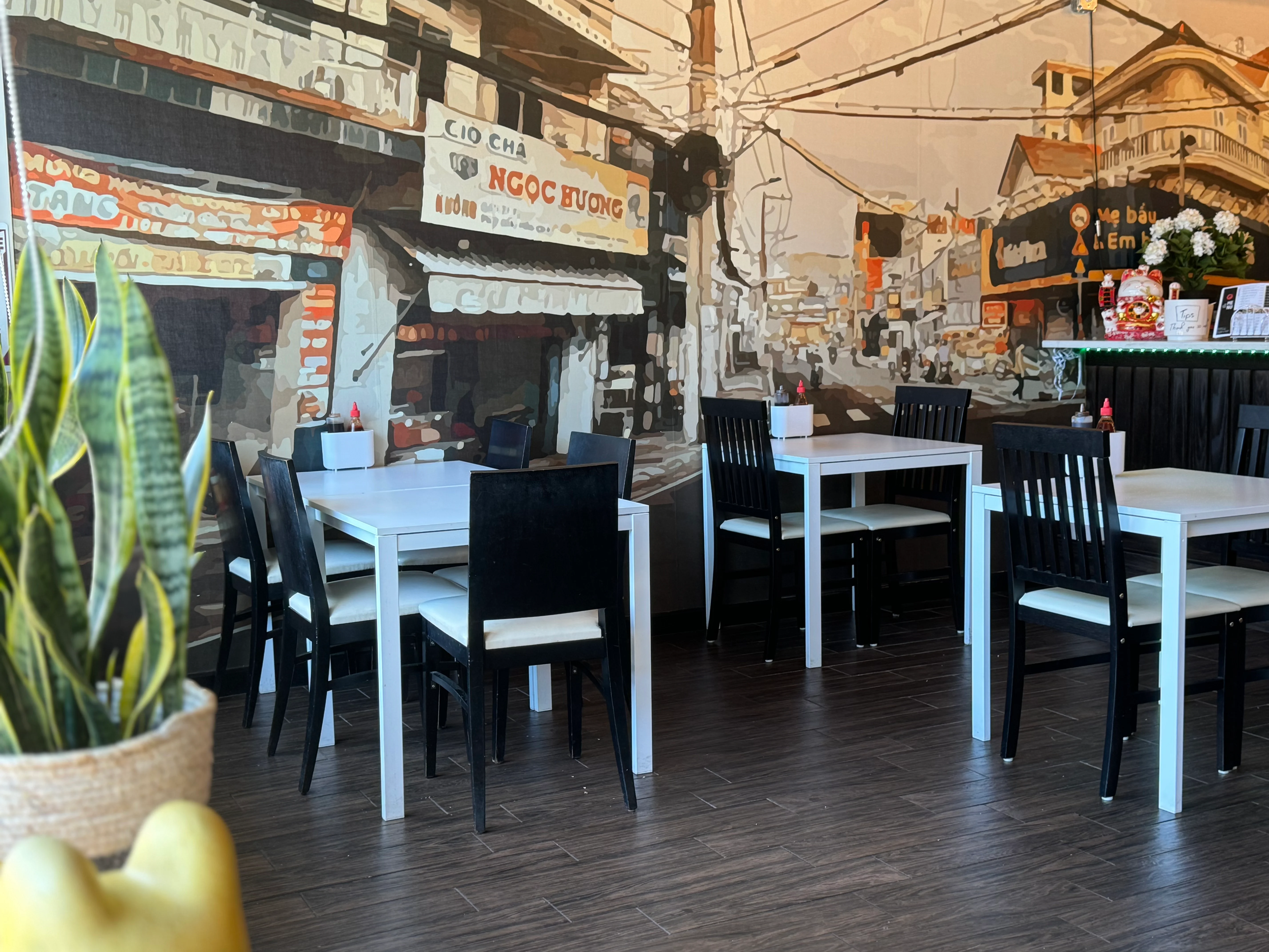Cozy restaurant interior with a mural of a bustling street scene