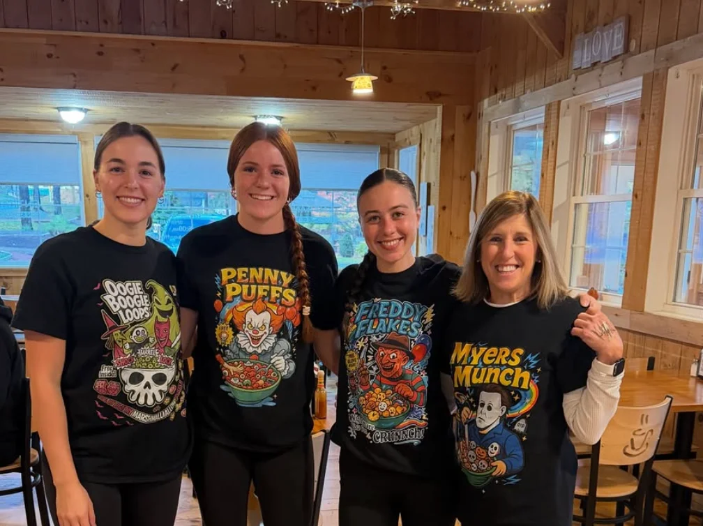 Group of friends in themed shirts at a cozy restaurant