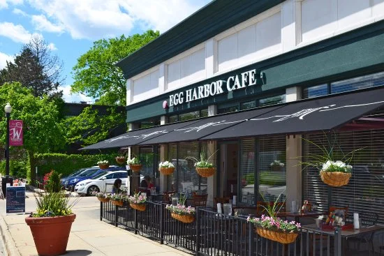Charming café exterior with outdoor seating and flower baskets