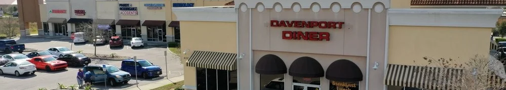 Exterior view of Davenport Diner with parking lot and shops