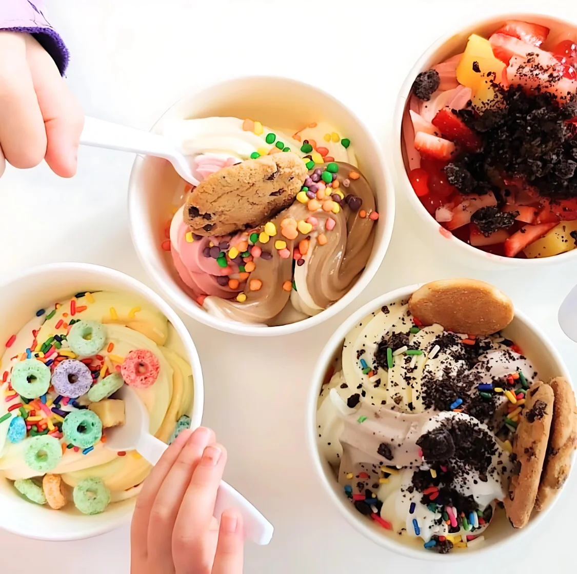 Colorful frozen yogurt bowls with toppings