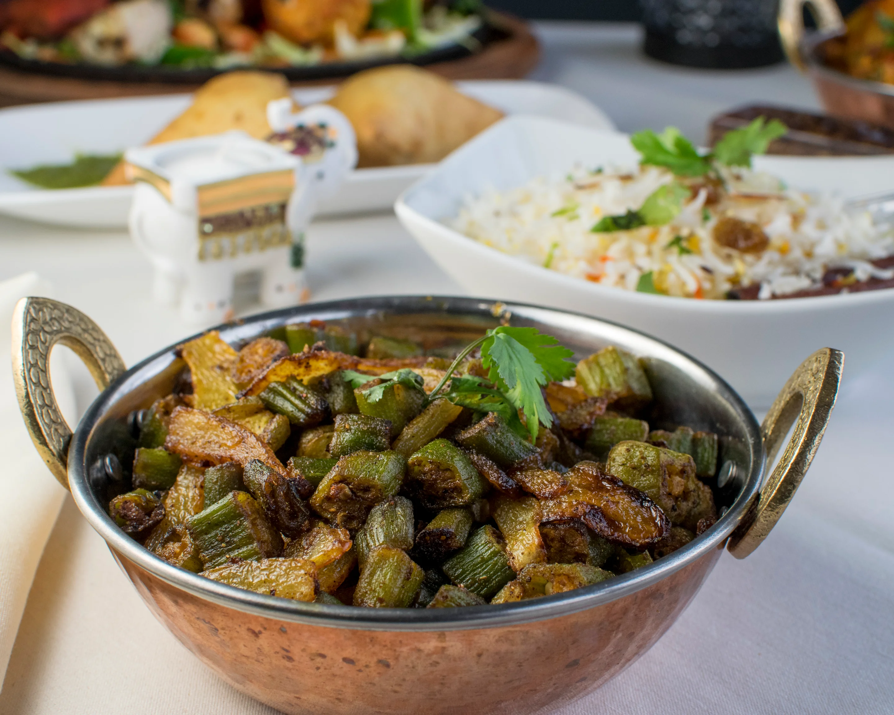 Indian bhindi masala served in a traditional copper bowl