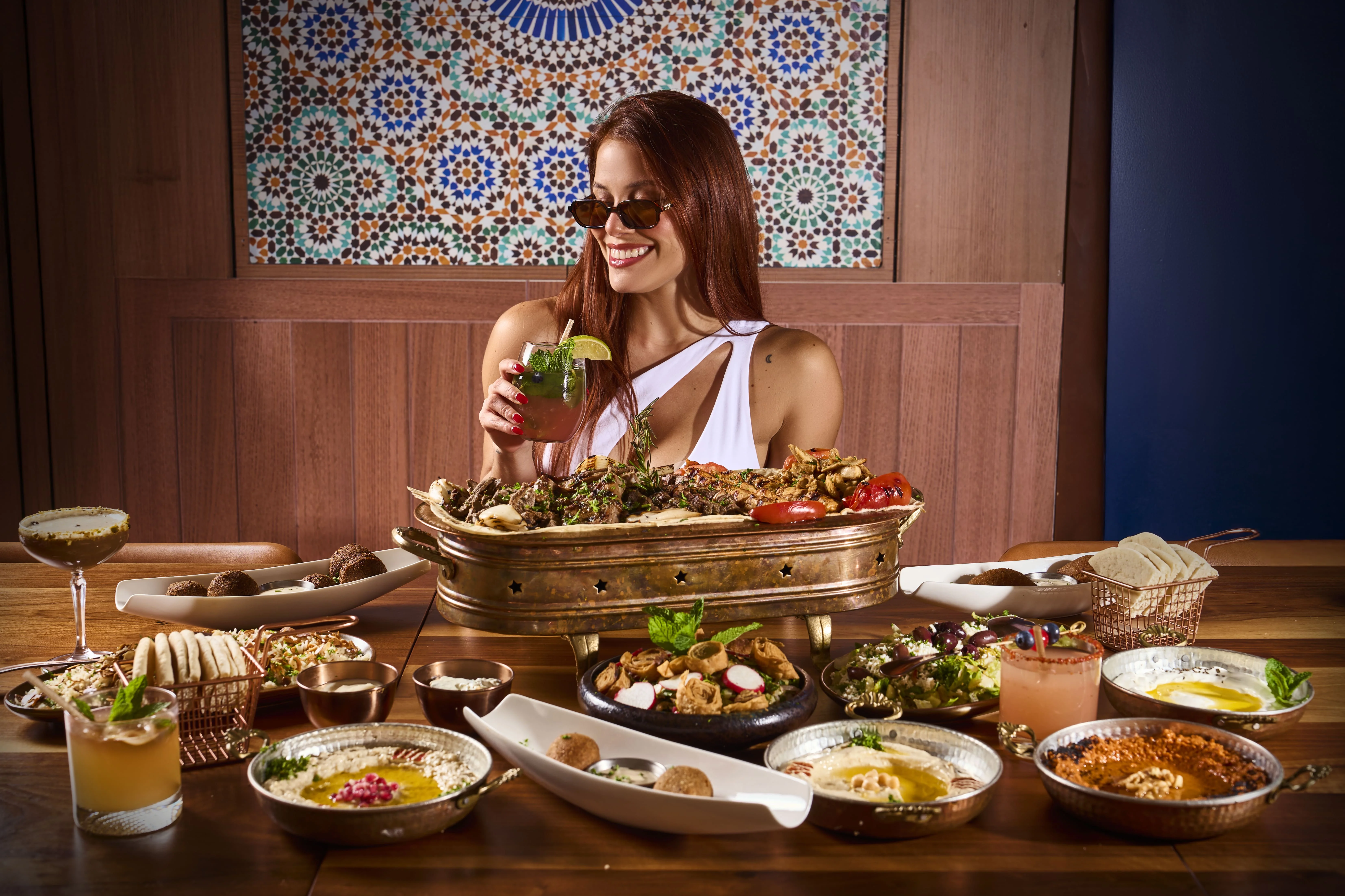 Guest enjoying Mediterranean cuisine at Sufrat Grill, Miami.