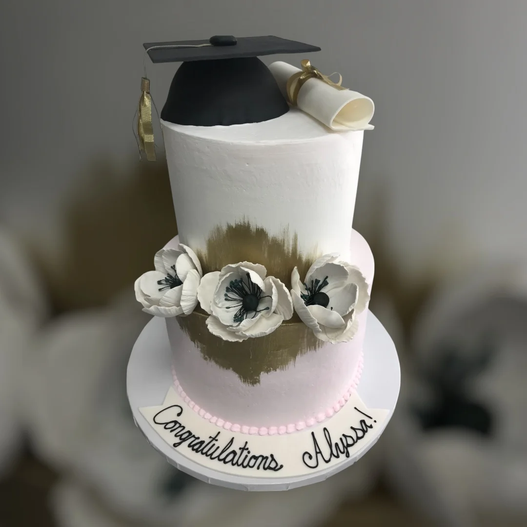 Graduation cake with cap and flowers for celebration