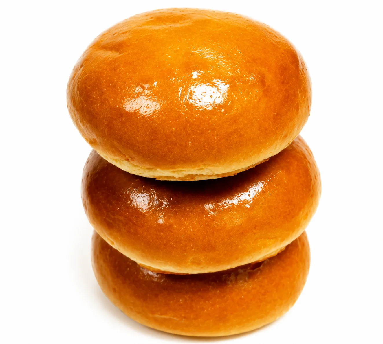 Three golden, shiny bread rolls stacked on top of each other.