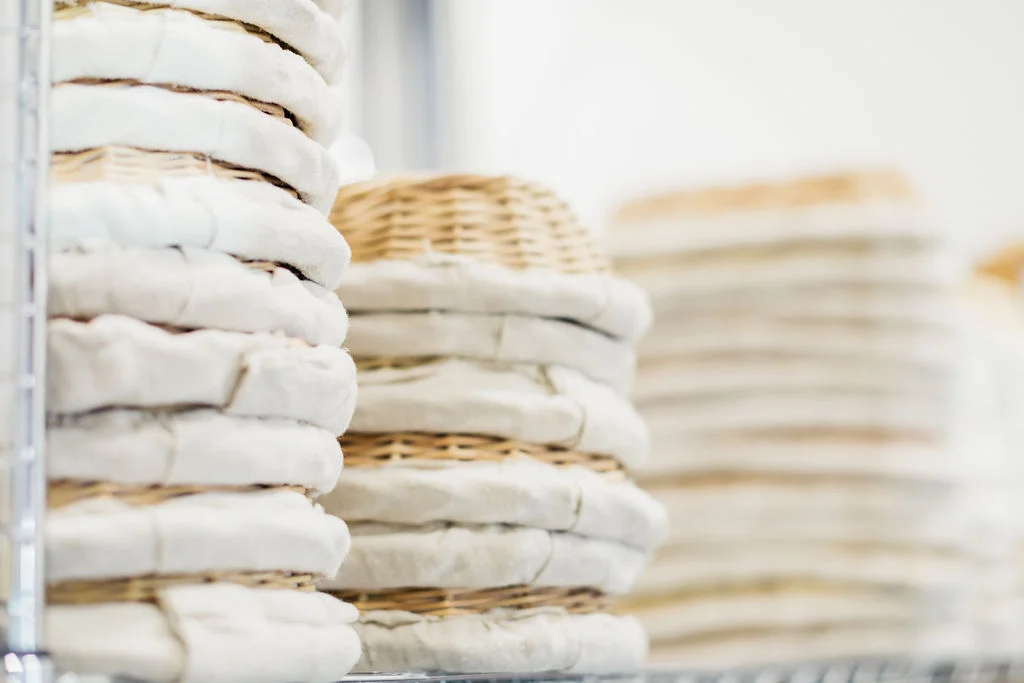 Stacked linen bread baskets in a restaurant kitchen
