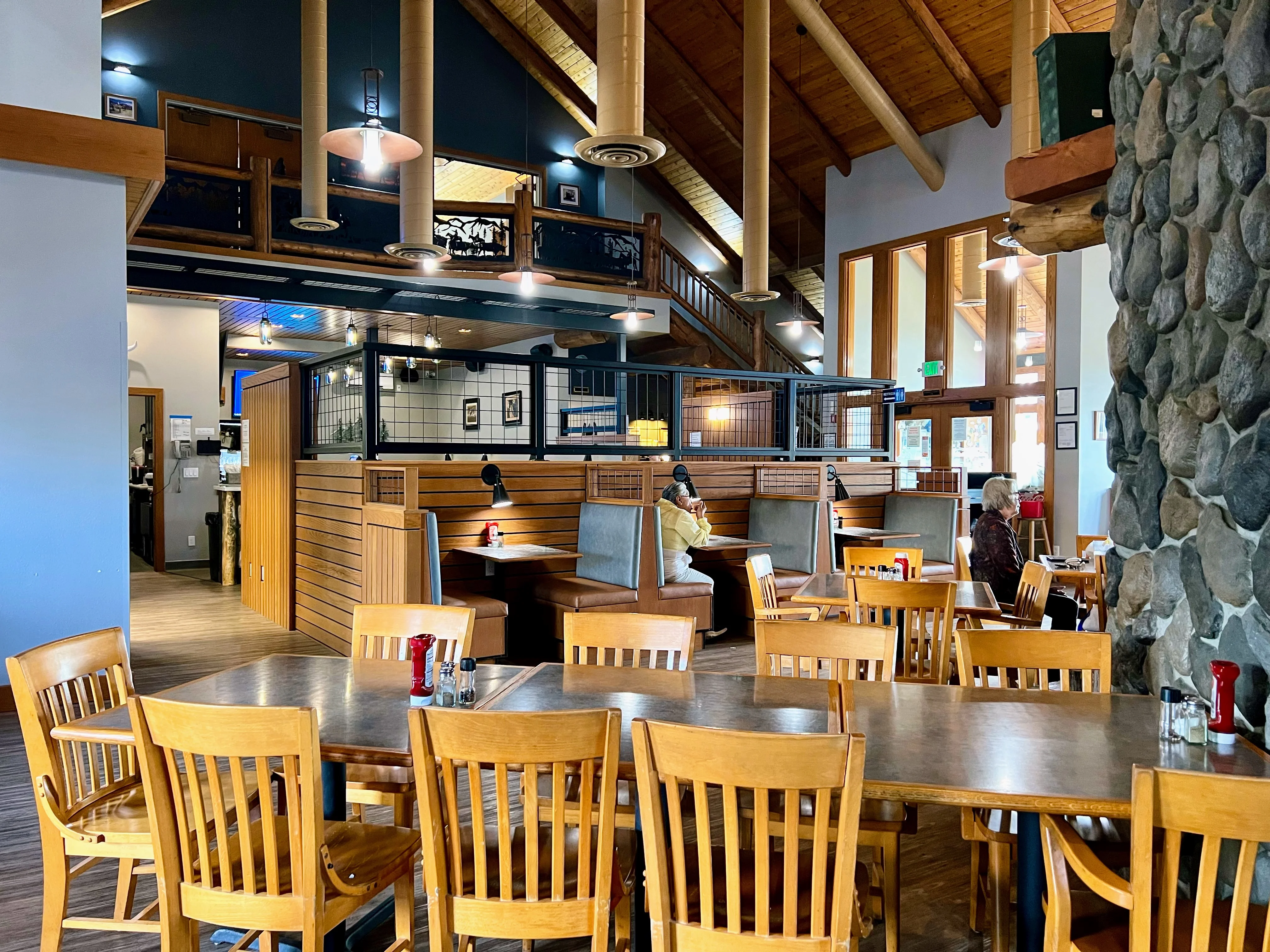 Cozy restaurant interior with wooden decor and booths