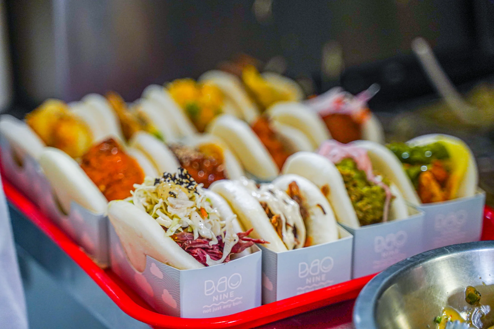 Assorted bao buns served on a red tray