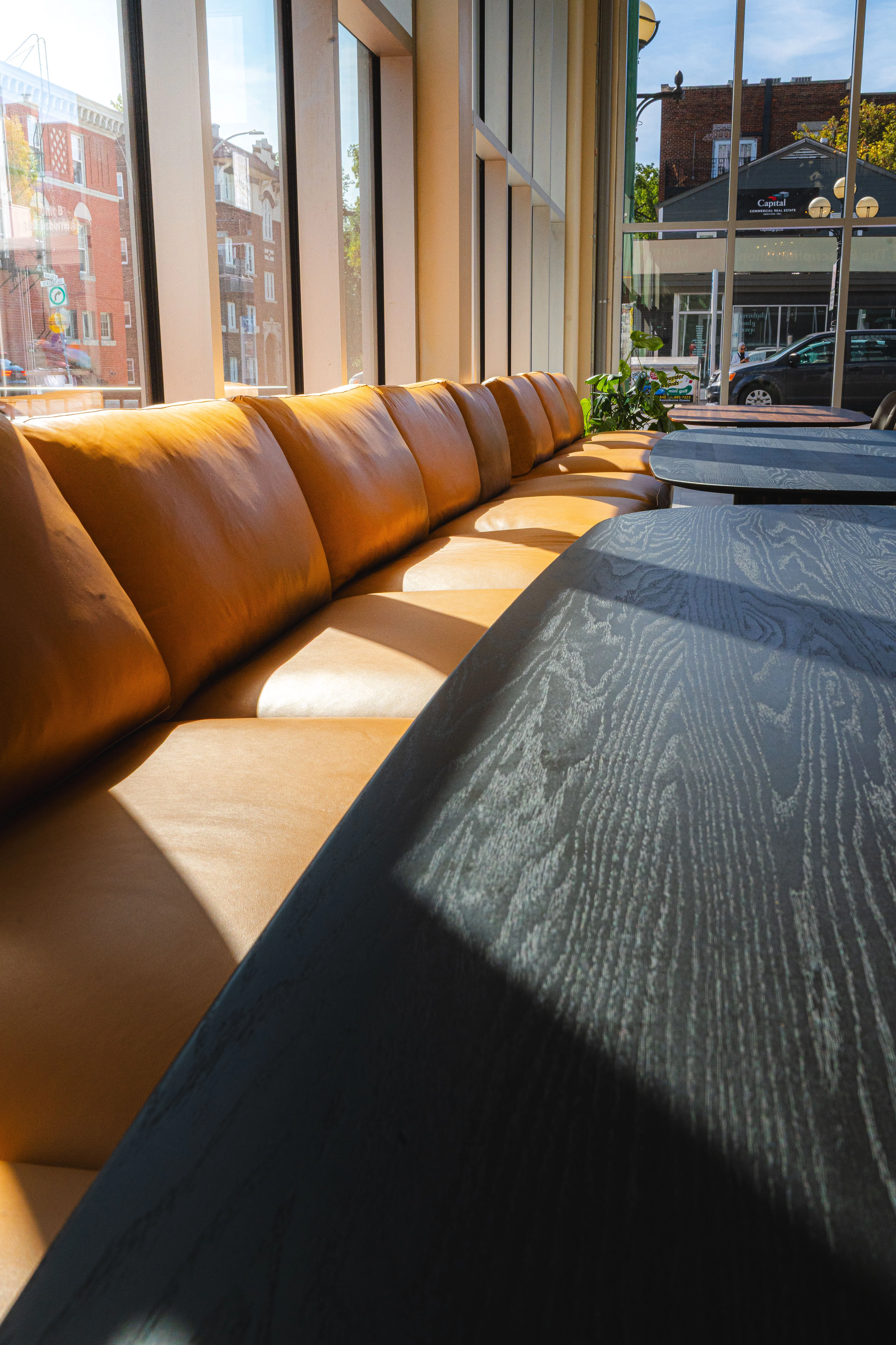 Cozy restaurant interior with leather seating and large windows