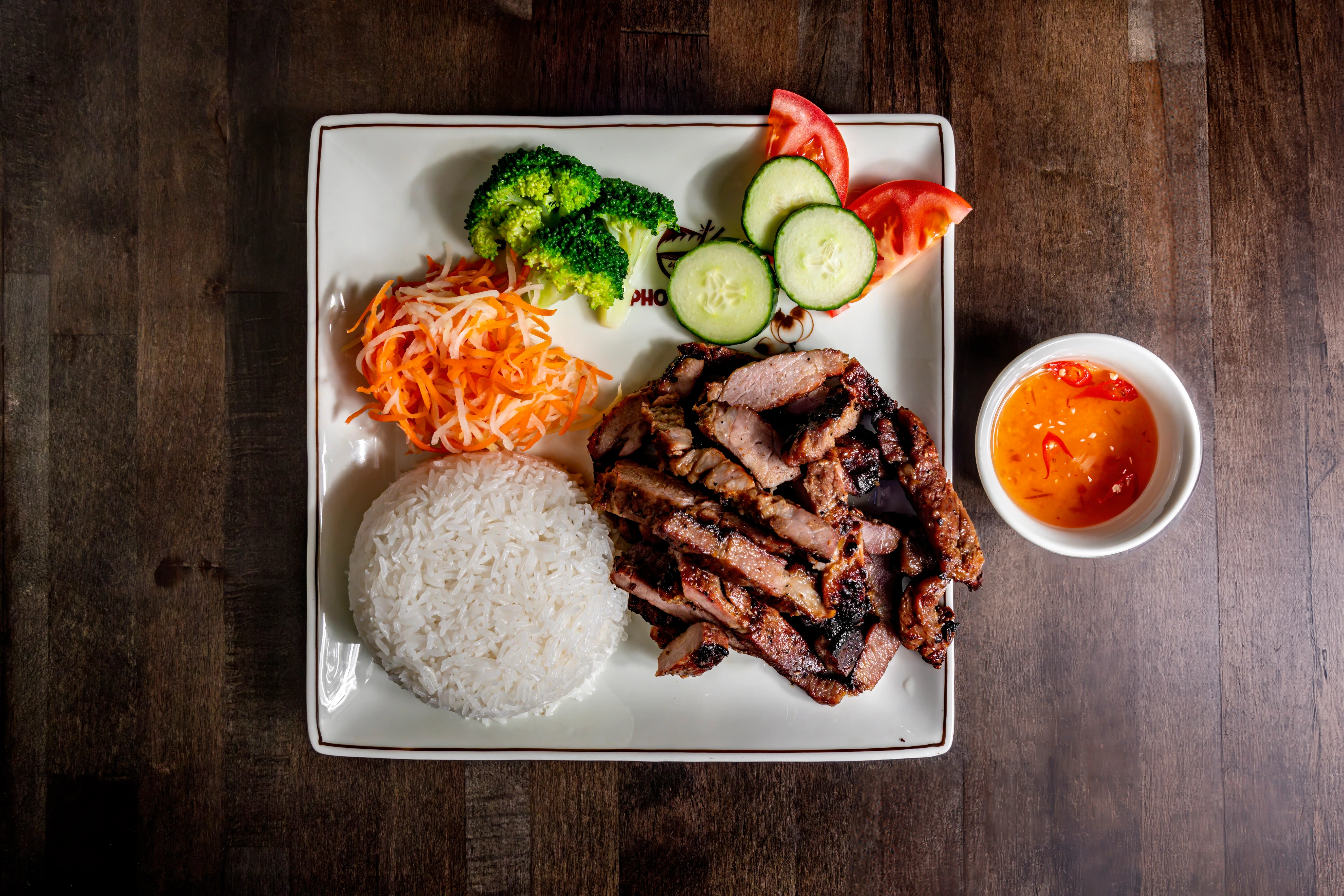 Grilled Vietnamese pork with rice and fresh vegetables
