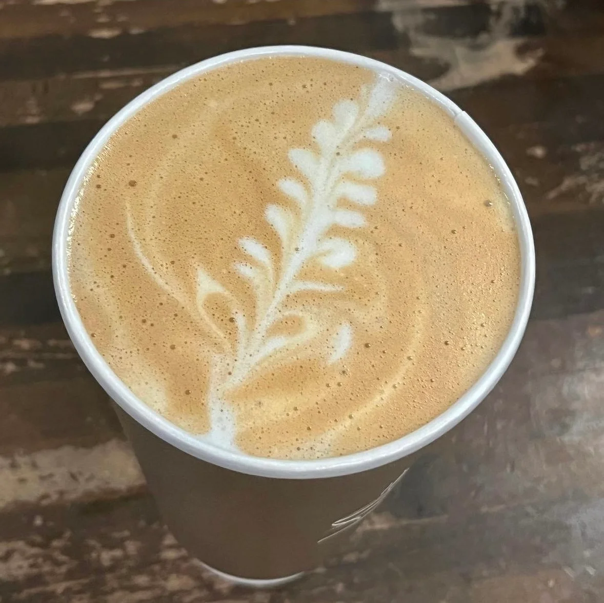 Artisan latte with beautiful leaf design