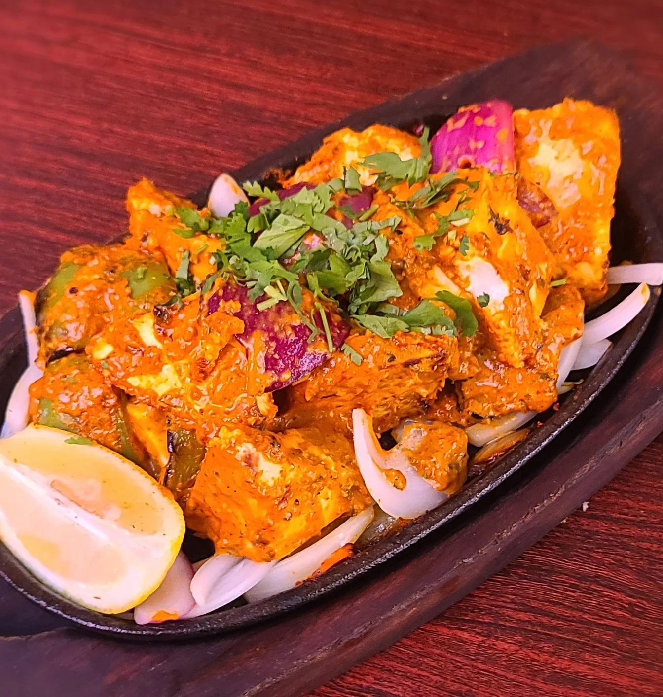 Paneer tikka kebab with peppers, onions, cilantro and lemon at Sugandh