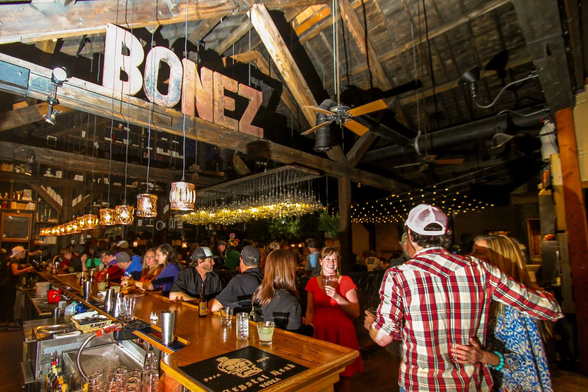 Lively bar interior with rustic decor and patrons enjoying drinks