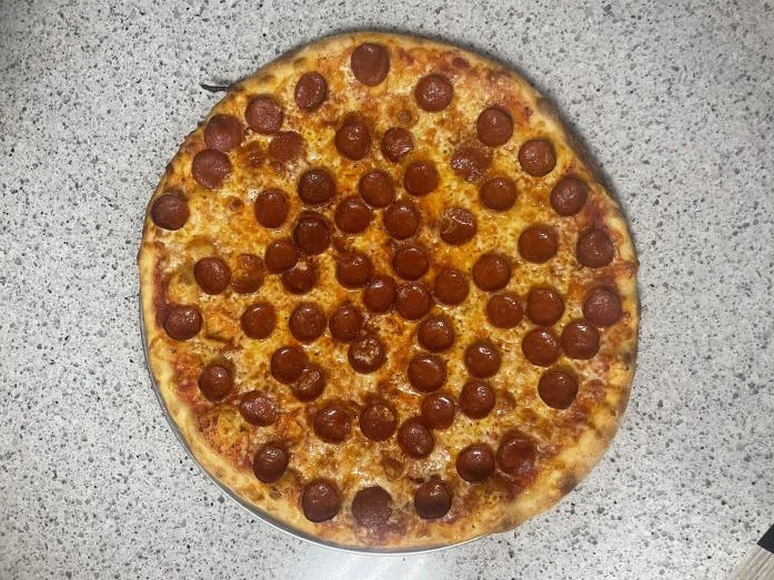 Classic pepperoni pizza on a stone countertop