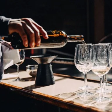 Pouring wine into elegant glasses at a bar