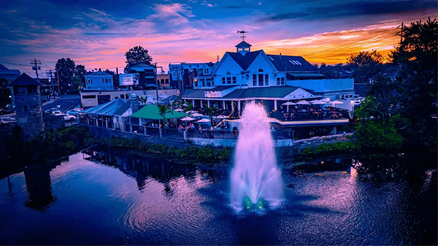 A vibrant fountain surrounded by greenery in a restaurant setting.