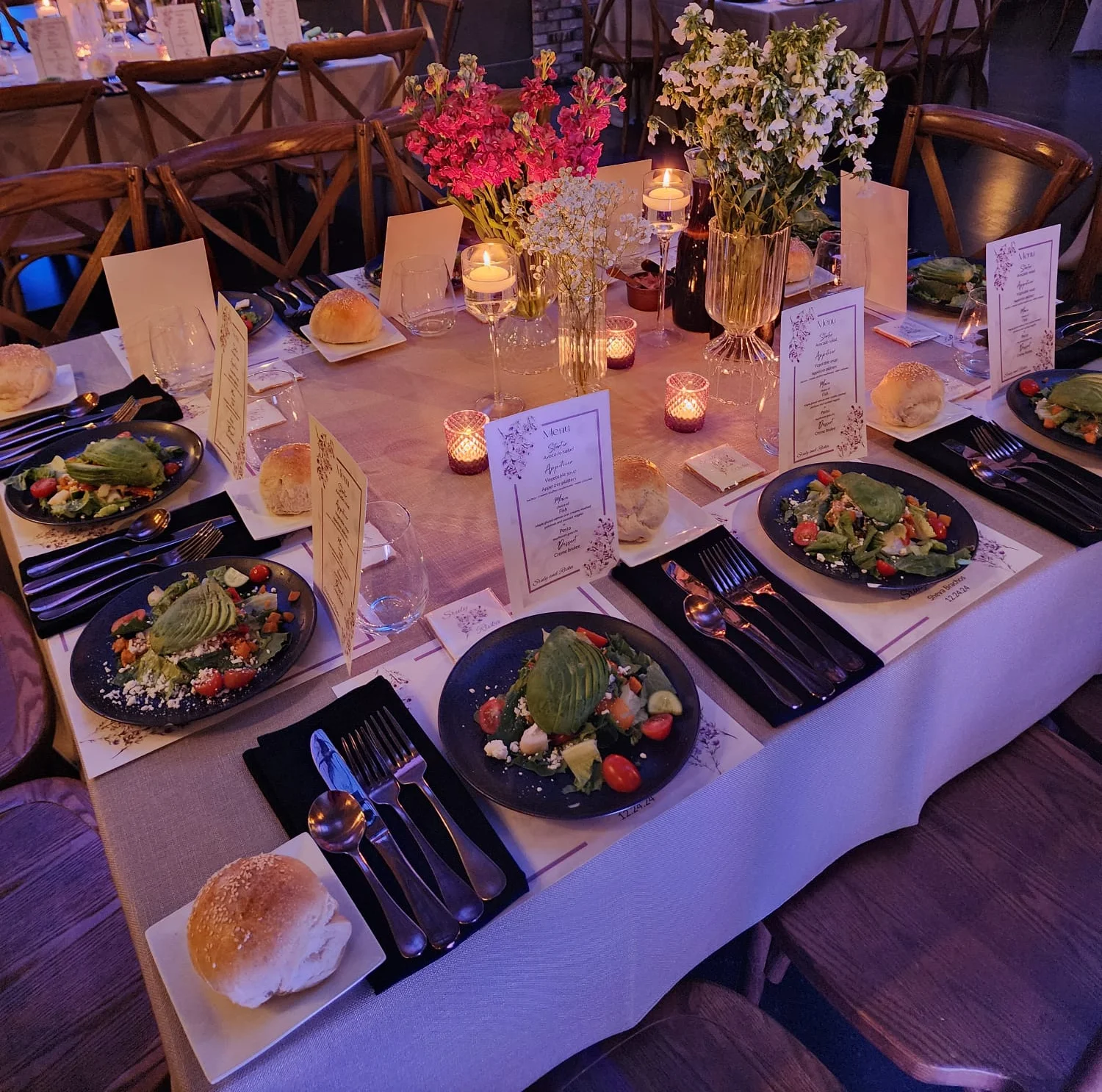 Elegant dining setup with fresh salads and floral decor