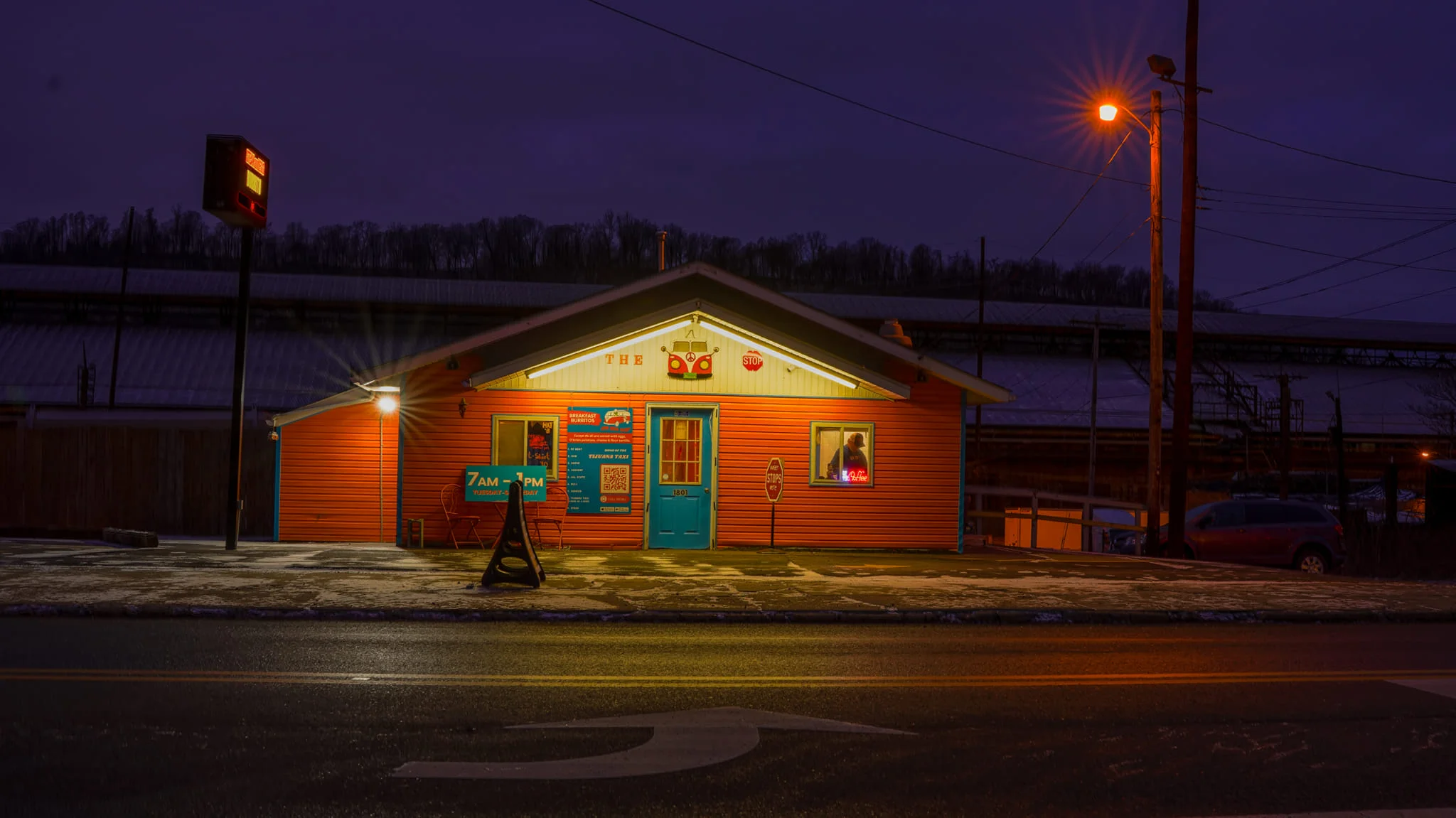 Colorful restaurant exterior at dusk with warm lighting