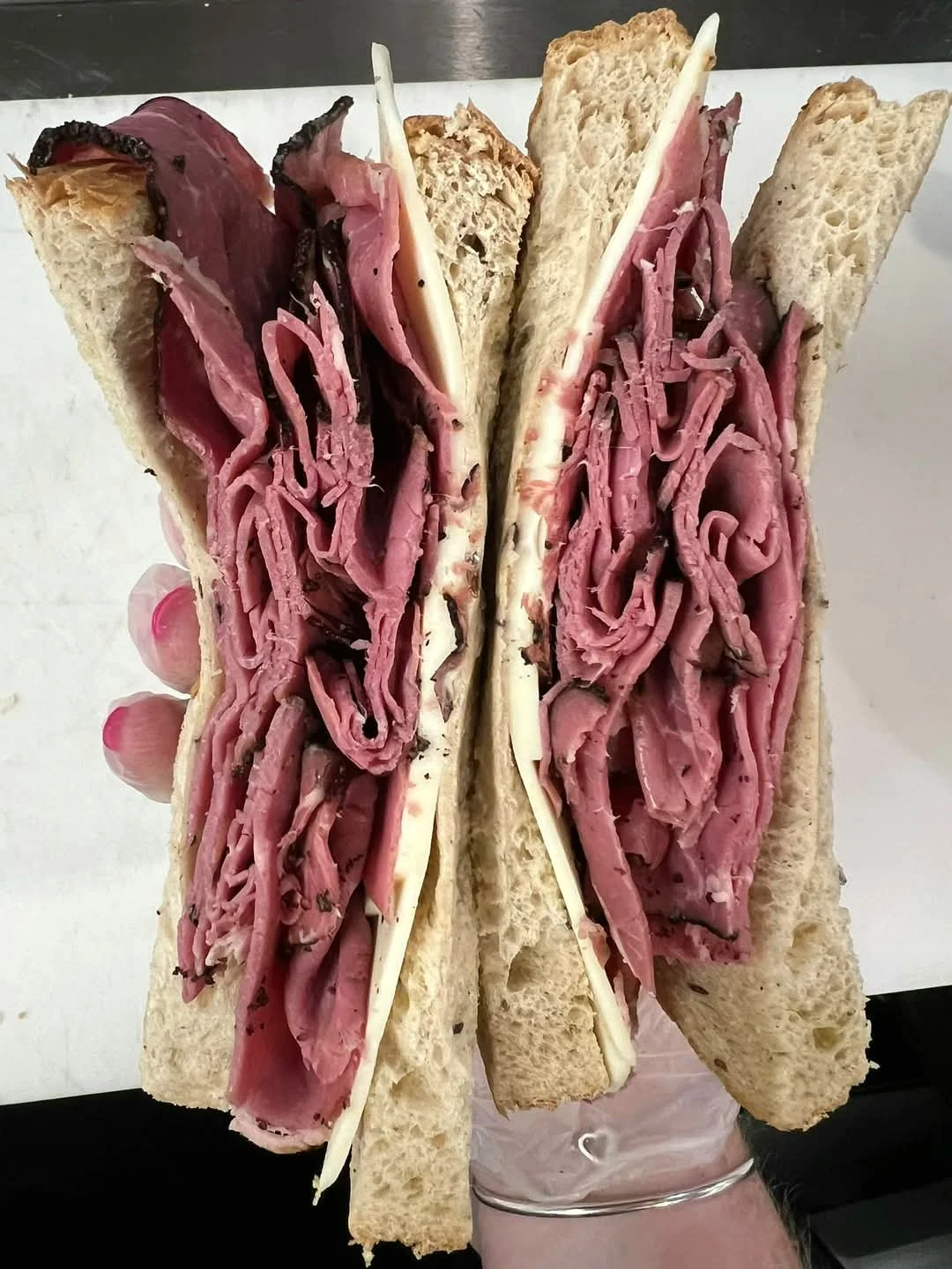 Classic deli pastrami sandwich on rye bread