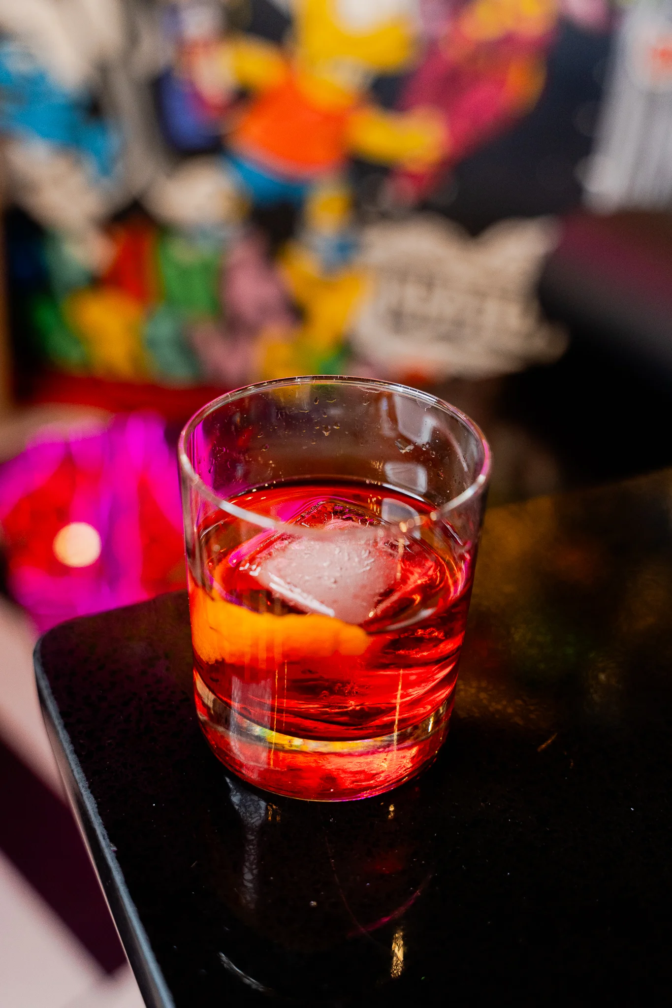 Colorful cocktails served in elegant glasses on a bar counter.