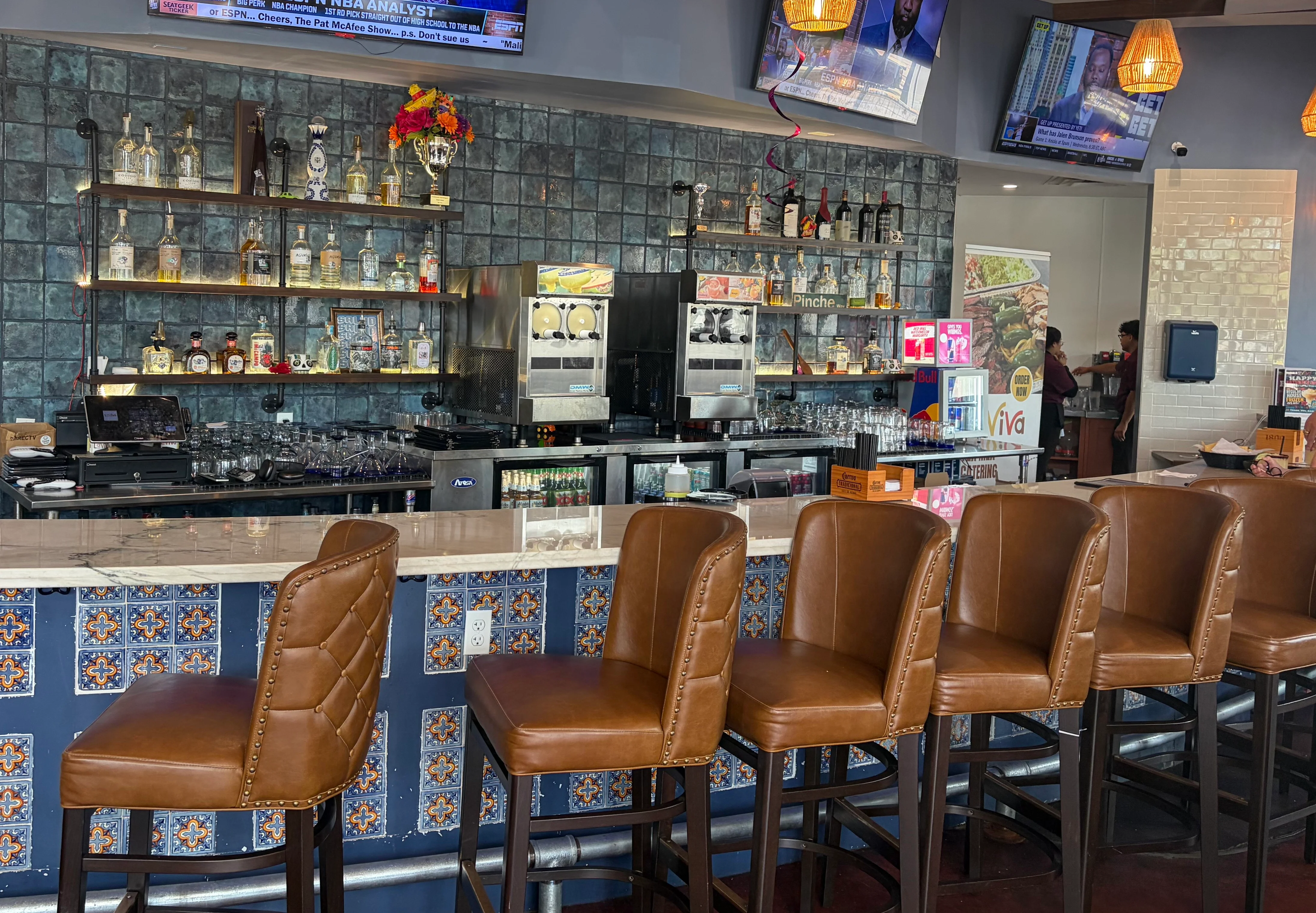 Modern bar interior with stylish seating and multiple TVs