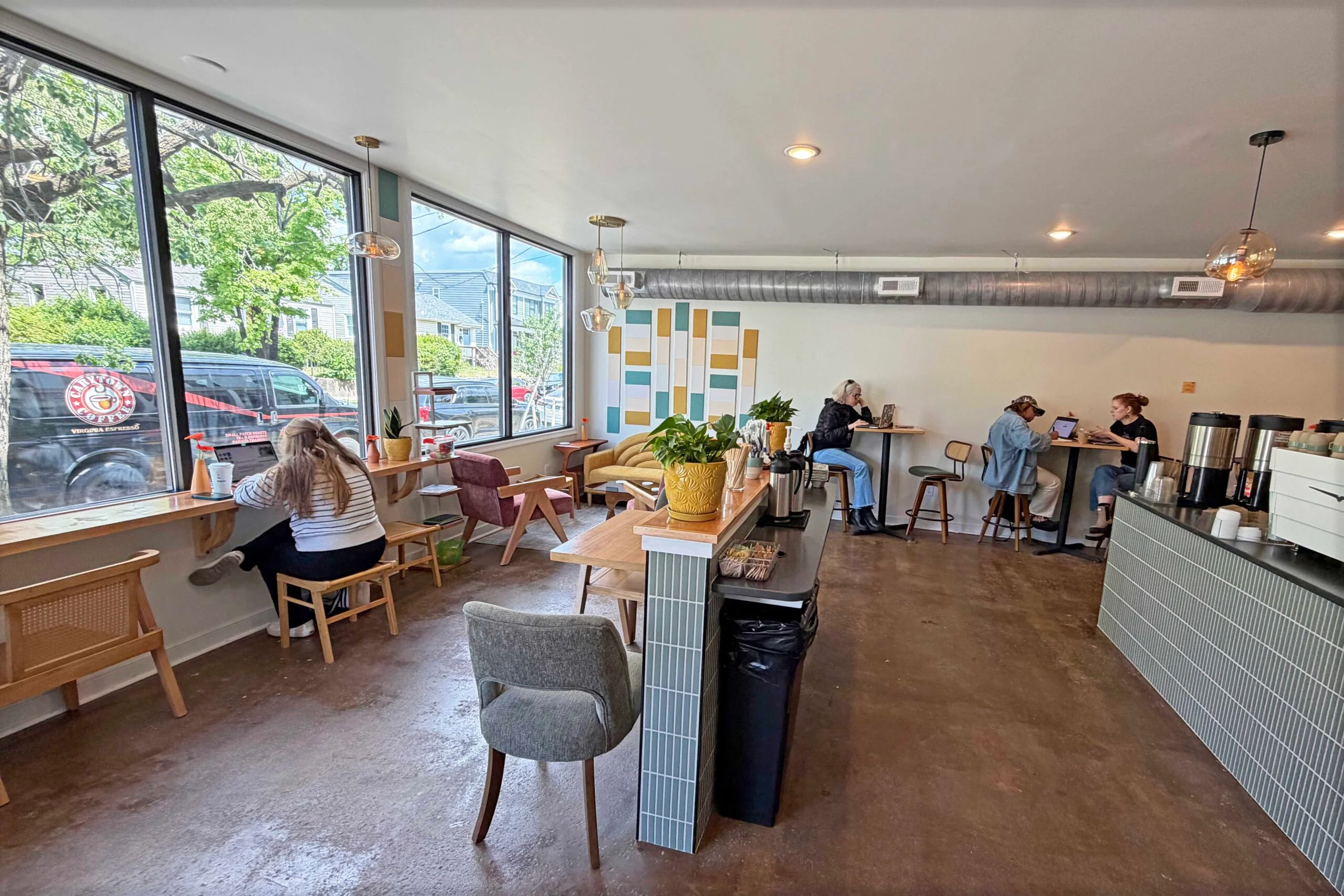 Modern café interior with cozy seating and large windows