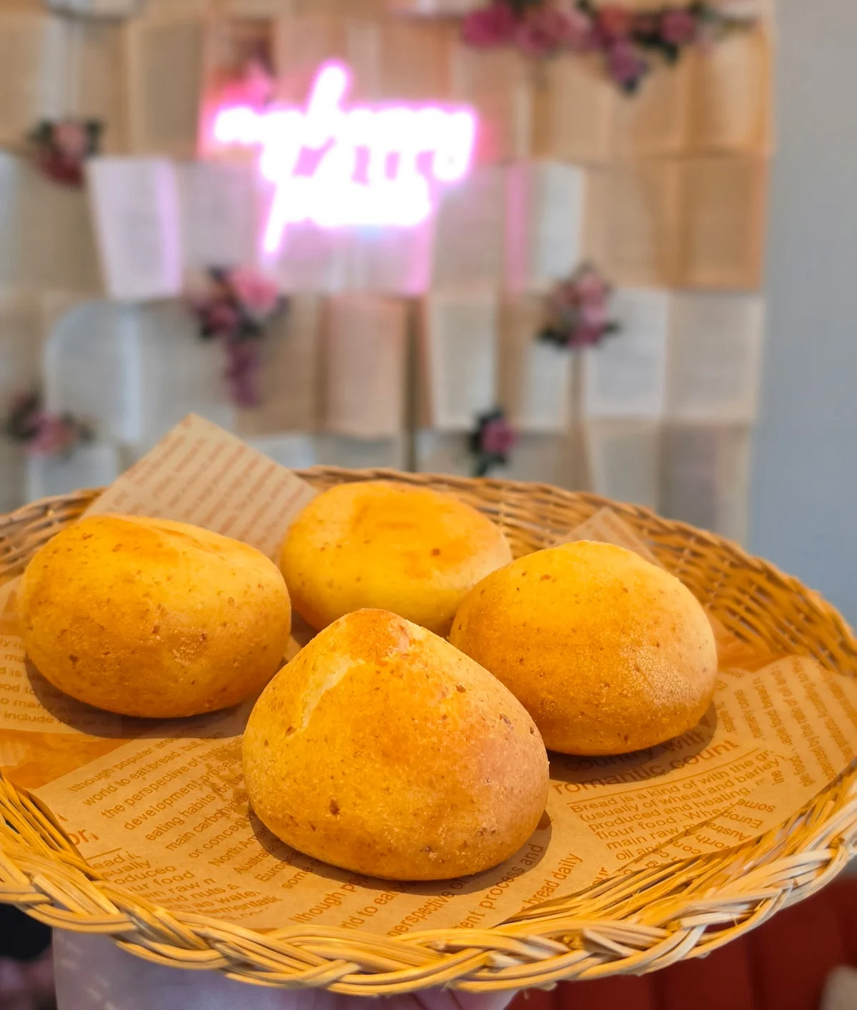 Freshly baked Brazilian pão de queijo in a woven basket