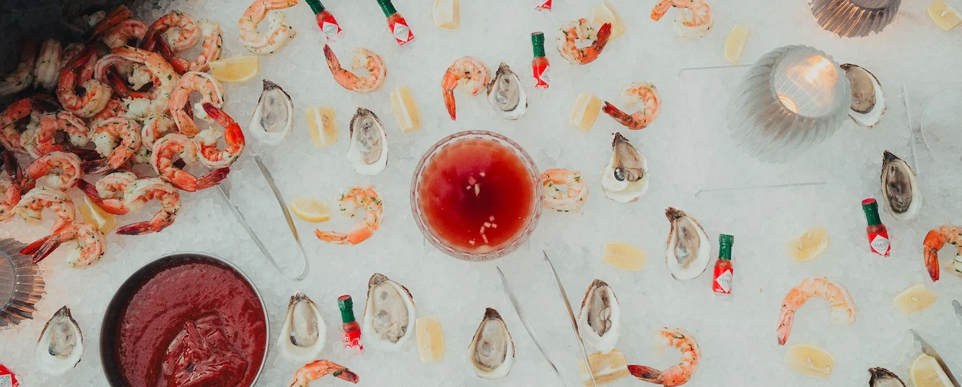 Seafood platter with shrimp and oysters on ice