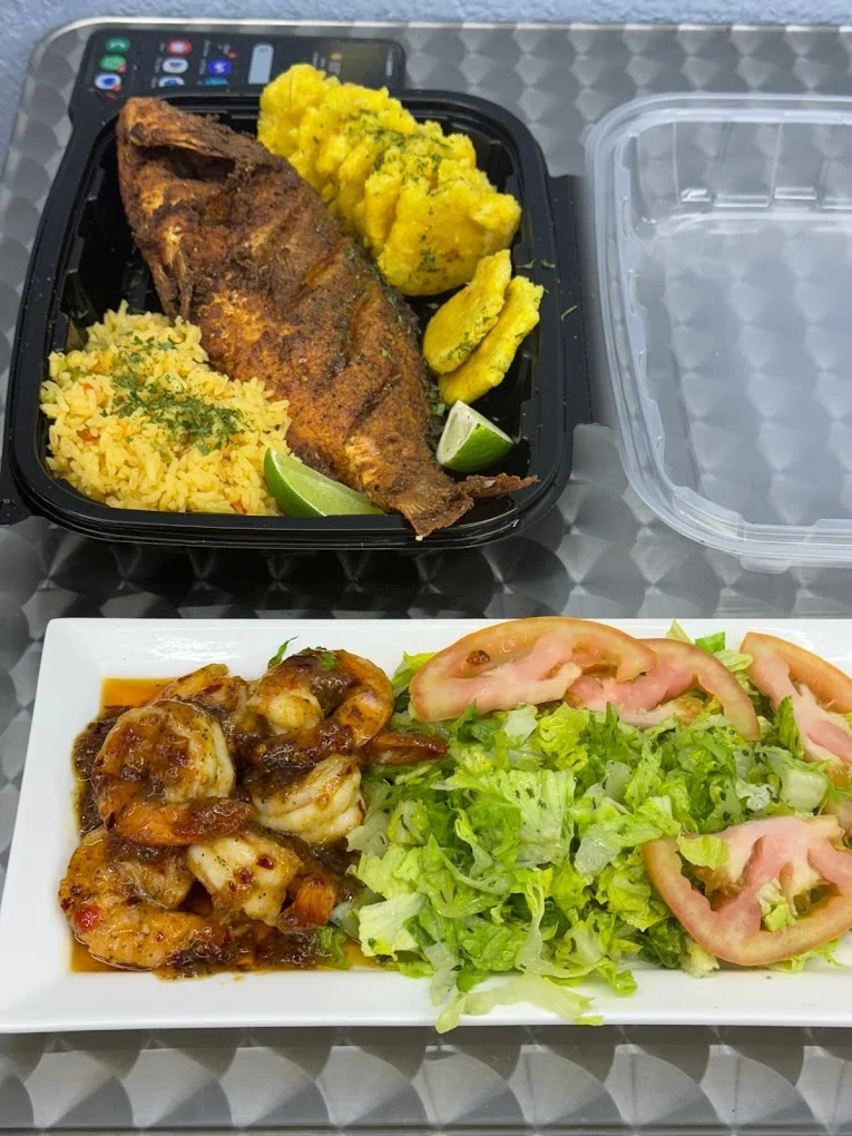 Crispy fried fish with rice and shrimp in a Caribbean platter