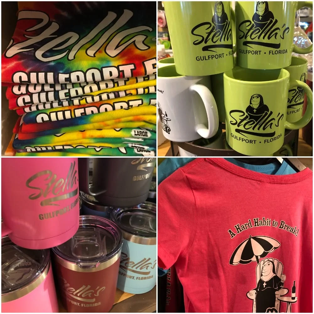 Colorful merchandise display featuring Stella's branded apparel and drinkware