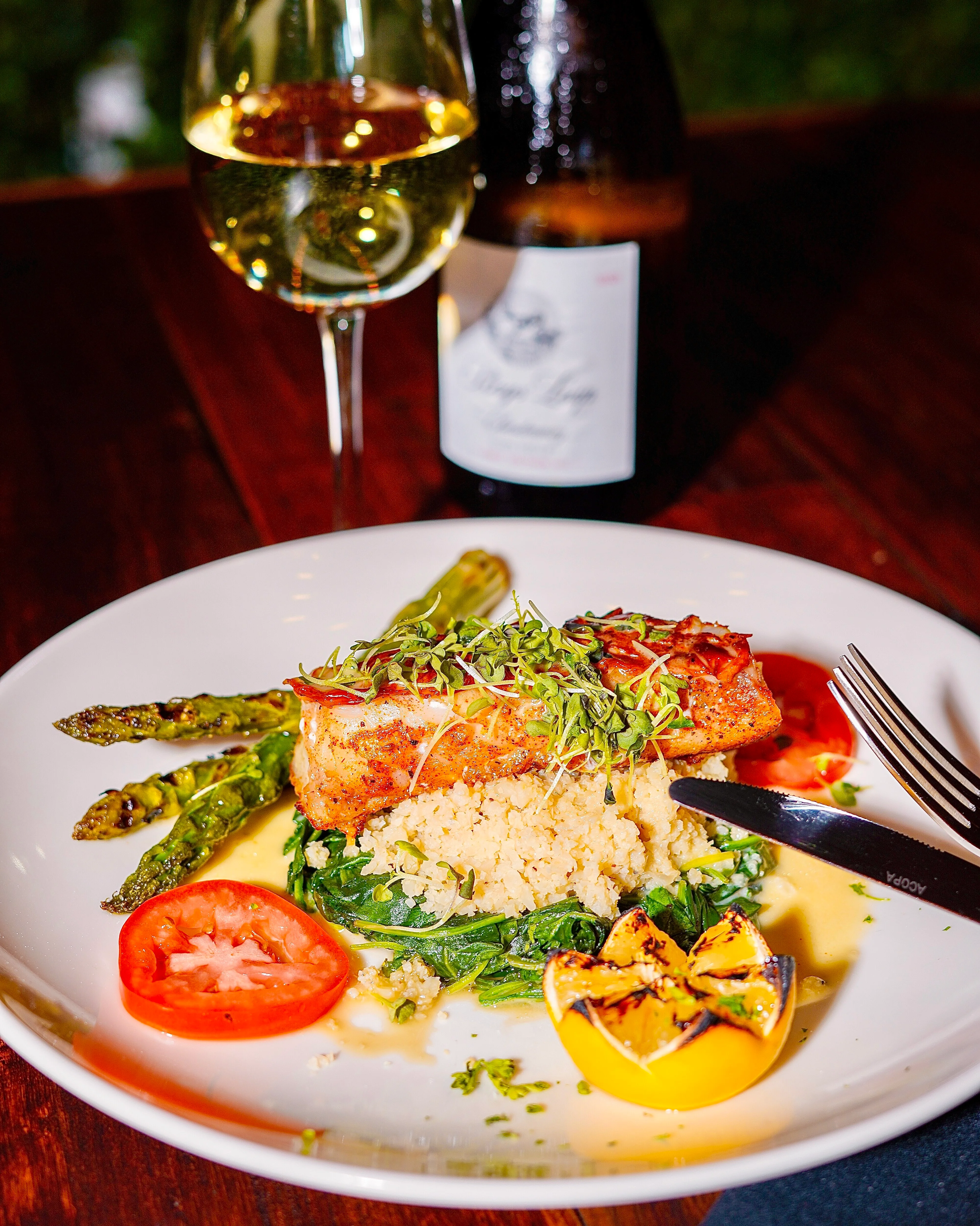 Grilled salmon with couscous and asparagus in a fine dining setting