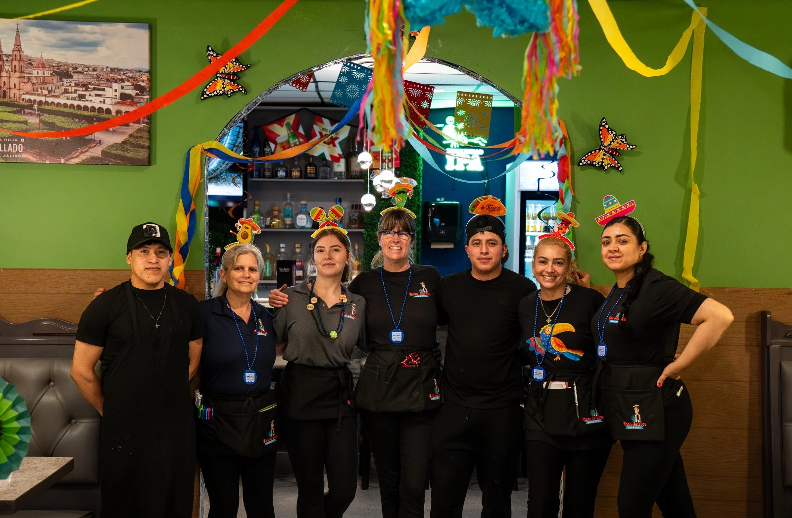 Colorful restaurant staff celebrating with festive decorations