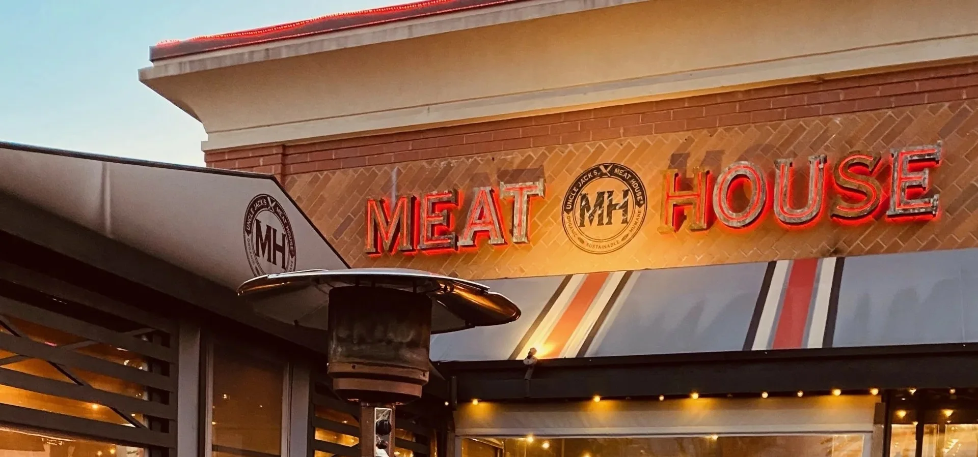 Outdoor seating area of Meat House restaurant with cozy ambiance