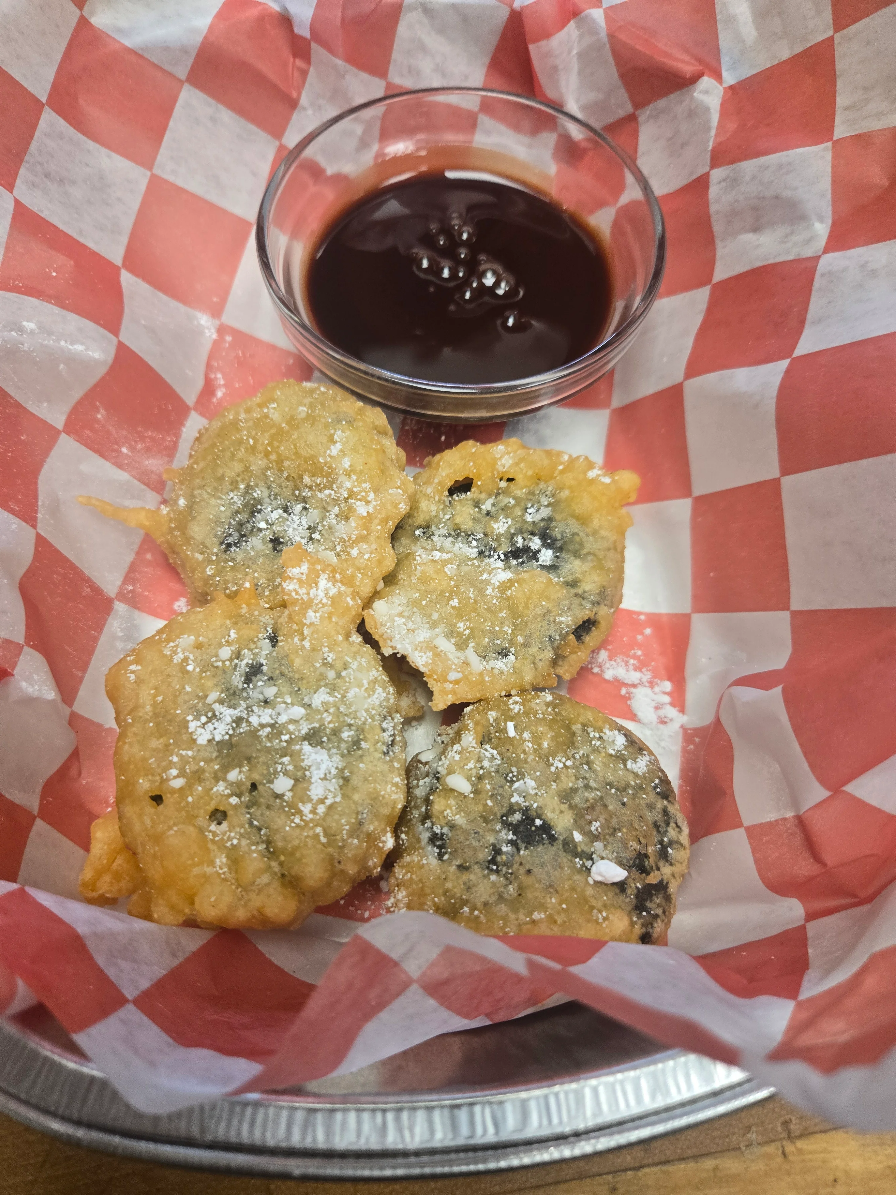 Fried black sesame balls with dipping sauce