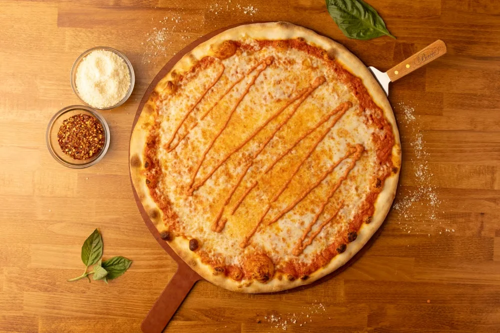 Classic cheese pizza with a golden crust and drizzled sauce