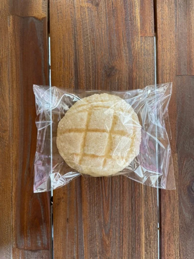 Mexican concha pastry wrapped in plastic