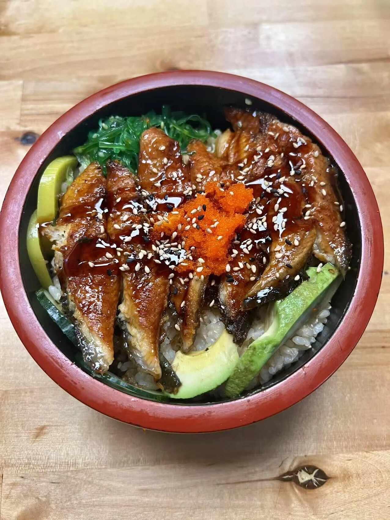 Japanese unadon with grilled eel over rice and garnishes