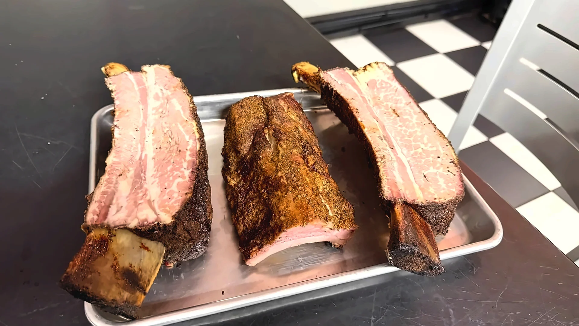 Texas-style smoked beef brisket and barbecue ribs on a tray