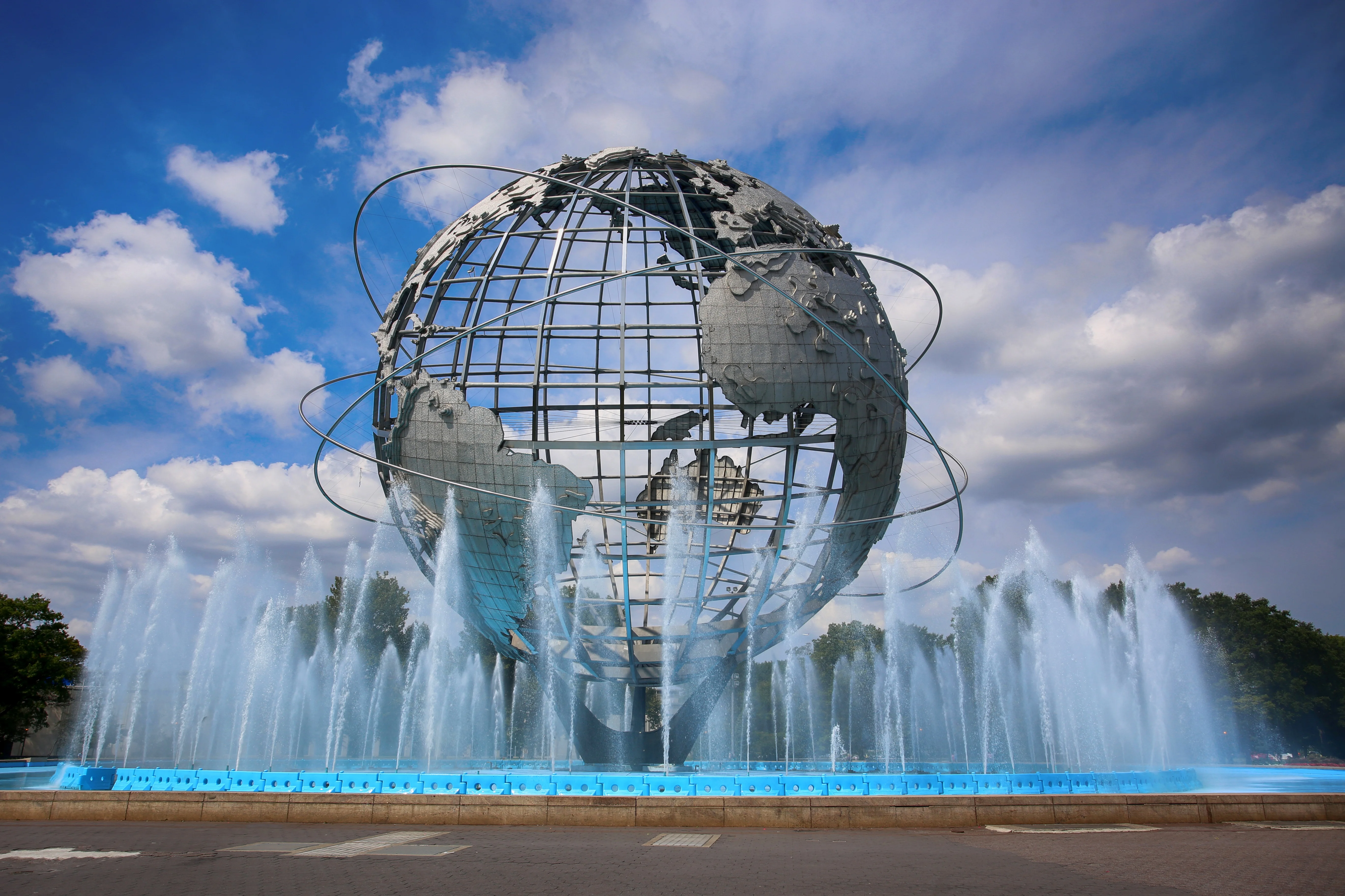 Iconic Unisphere fountain in Queens, New York under a blue sky