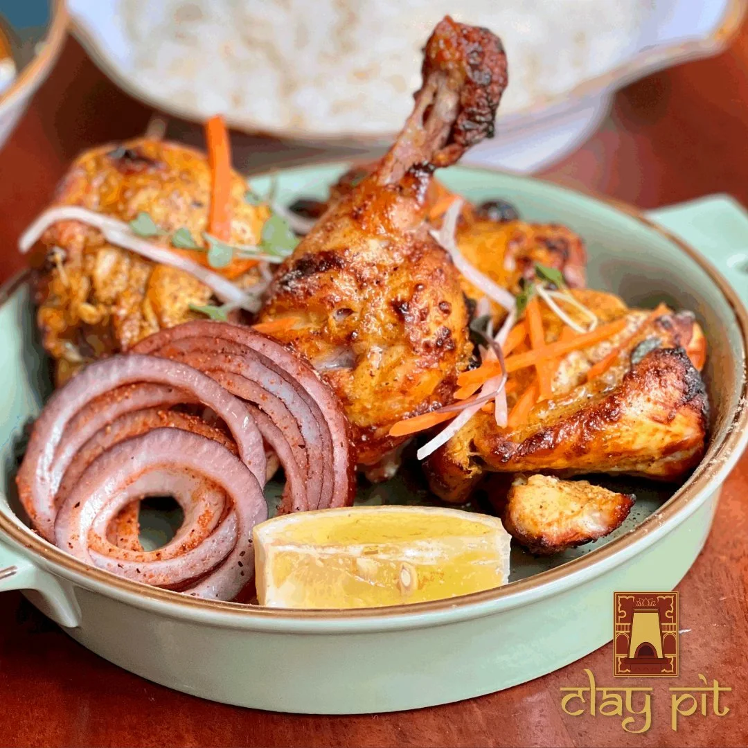 Tandoori chicken served with onions and lemon